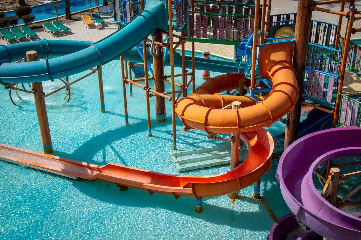 Outdoor water park with wave pool, slides, and crowds on a sunny summer day in Korea