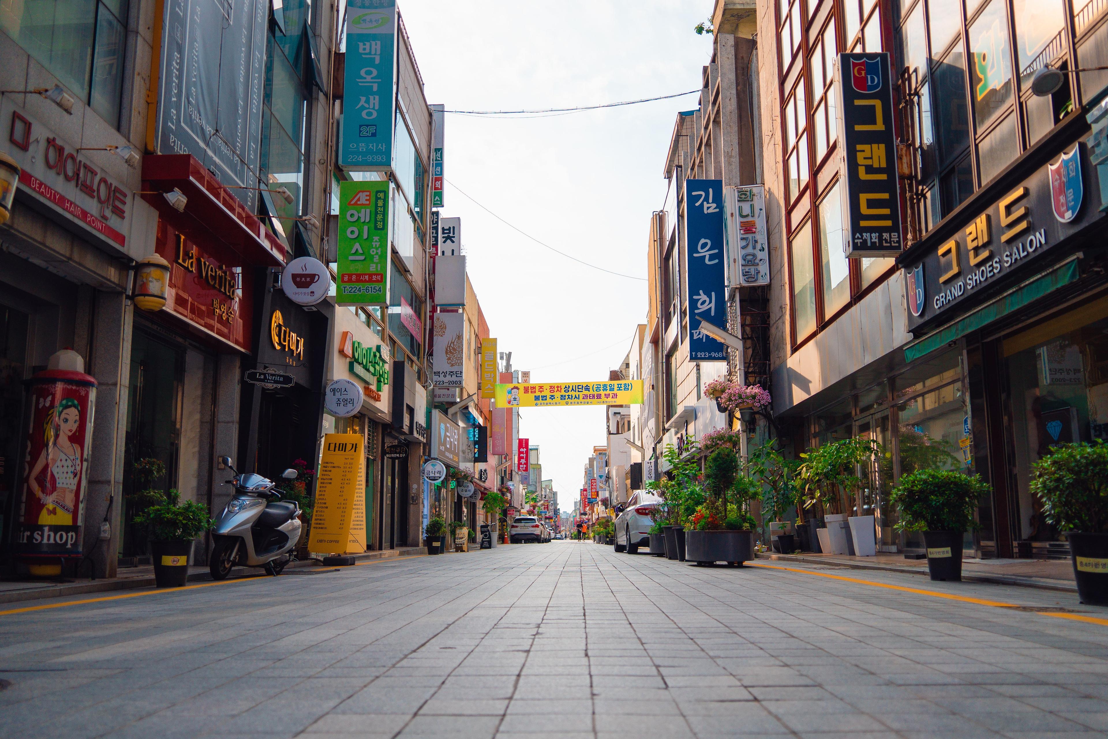Lively street in Gwangju downtown South Korea with shops and pedestrians during the day