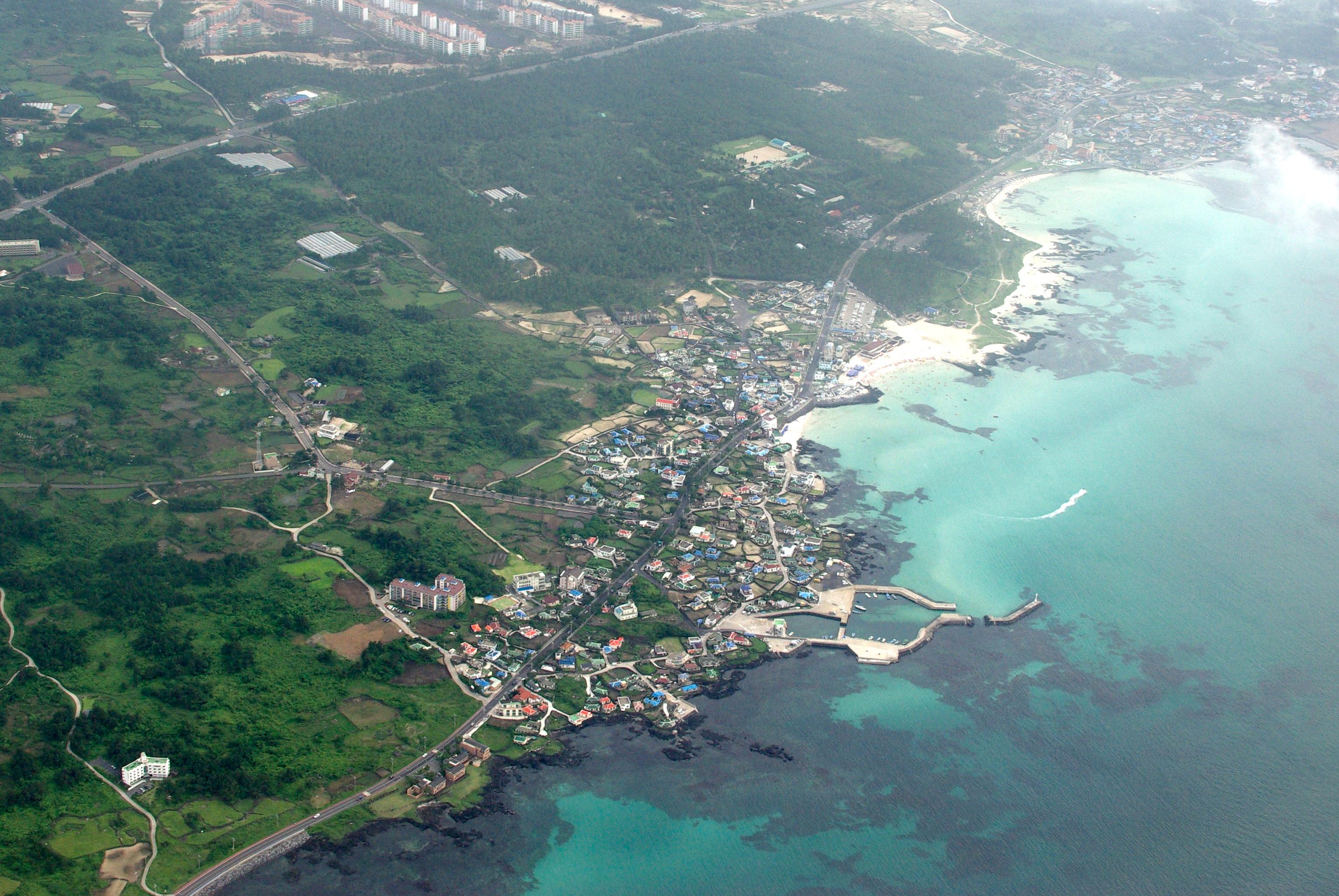 Hyeopjae Beach on Jeju Island, Korea with turquoise shallows and Biyangdo Island in distance