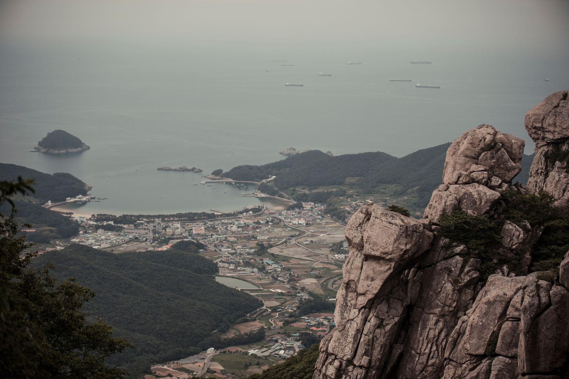 Rocky coastal town in South Korea with dramatic sea cliffs and calm blue waters