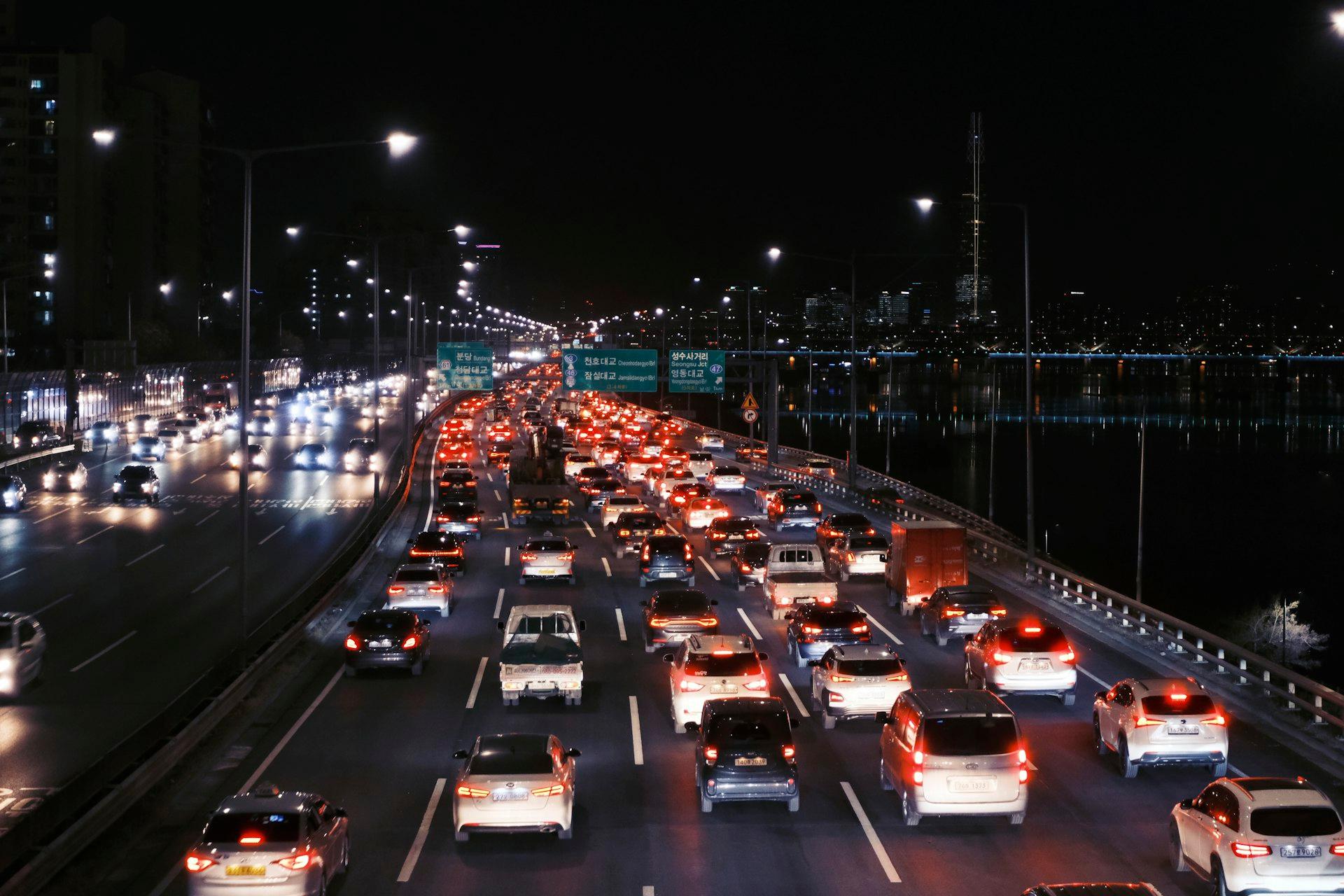 Cars backed up on a Seoul road at night during a busy travel period
