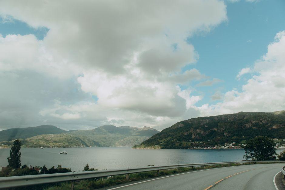 Lakeside road along Daecheong Lake near Okcheon with blue reservoir visible through trees