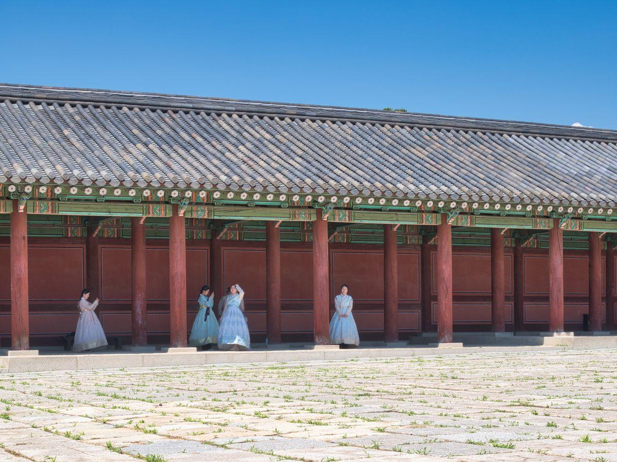 Visitors wearing colorful hanbok traditional Korean dress at Gyeongbokgung Palace