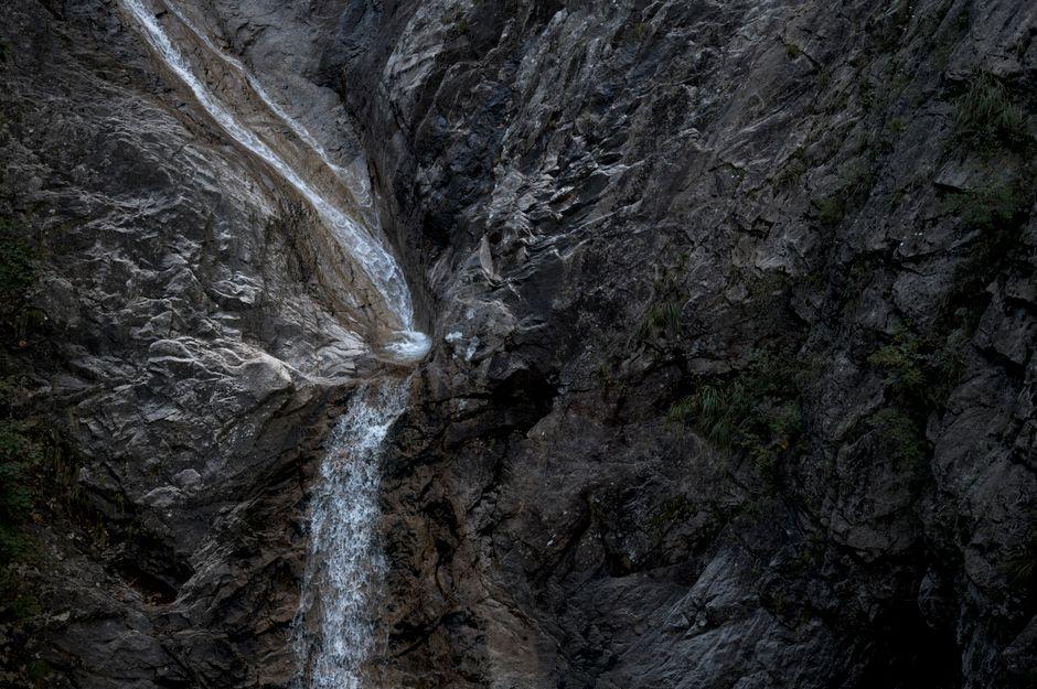 Waterfall cascading over volcanic rhyolite rock face in a Korean national park gorge, Juwangsan style canyon
