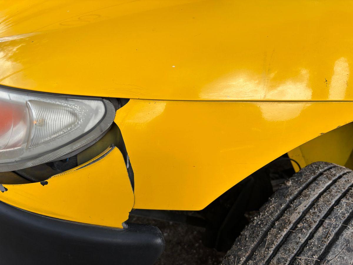 Close-up of car bumper damage, showing scratches that rental companies charge for