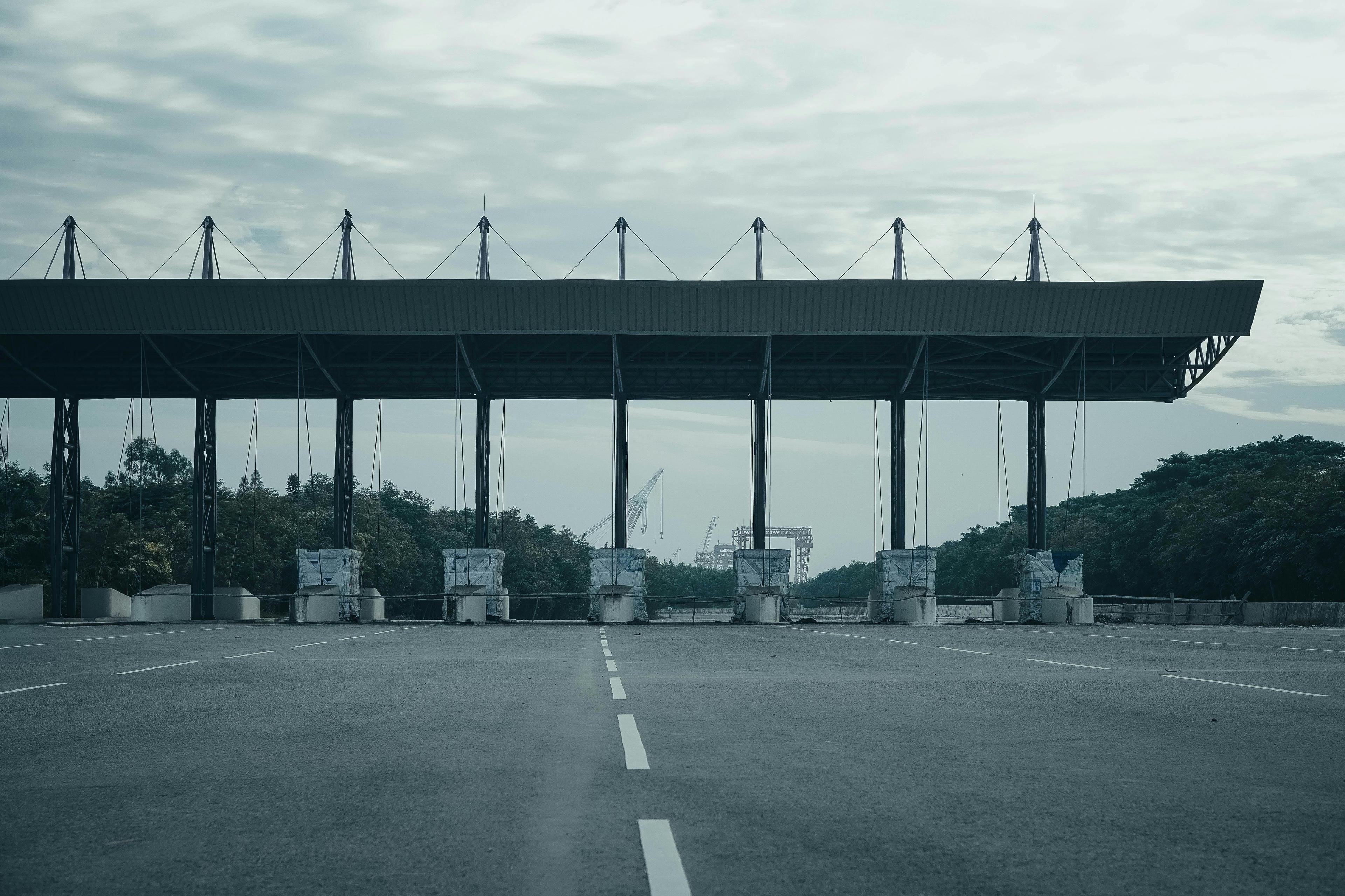 Empty expressway toll gate with overhead lane signage