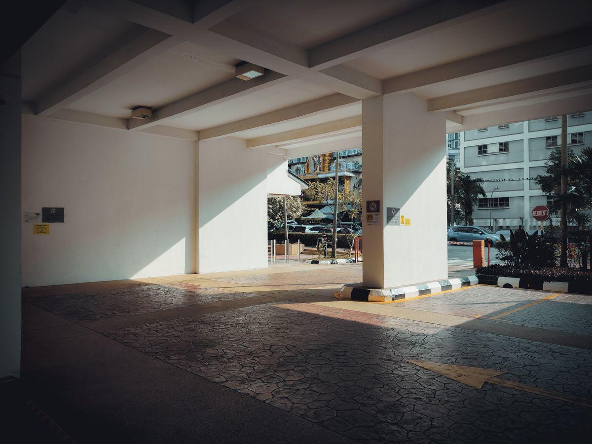 Sunlit entrance to an urban parking garage — parking in Korean cities is widely available but varies in price by location