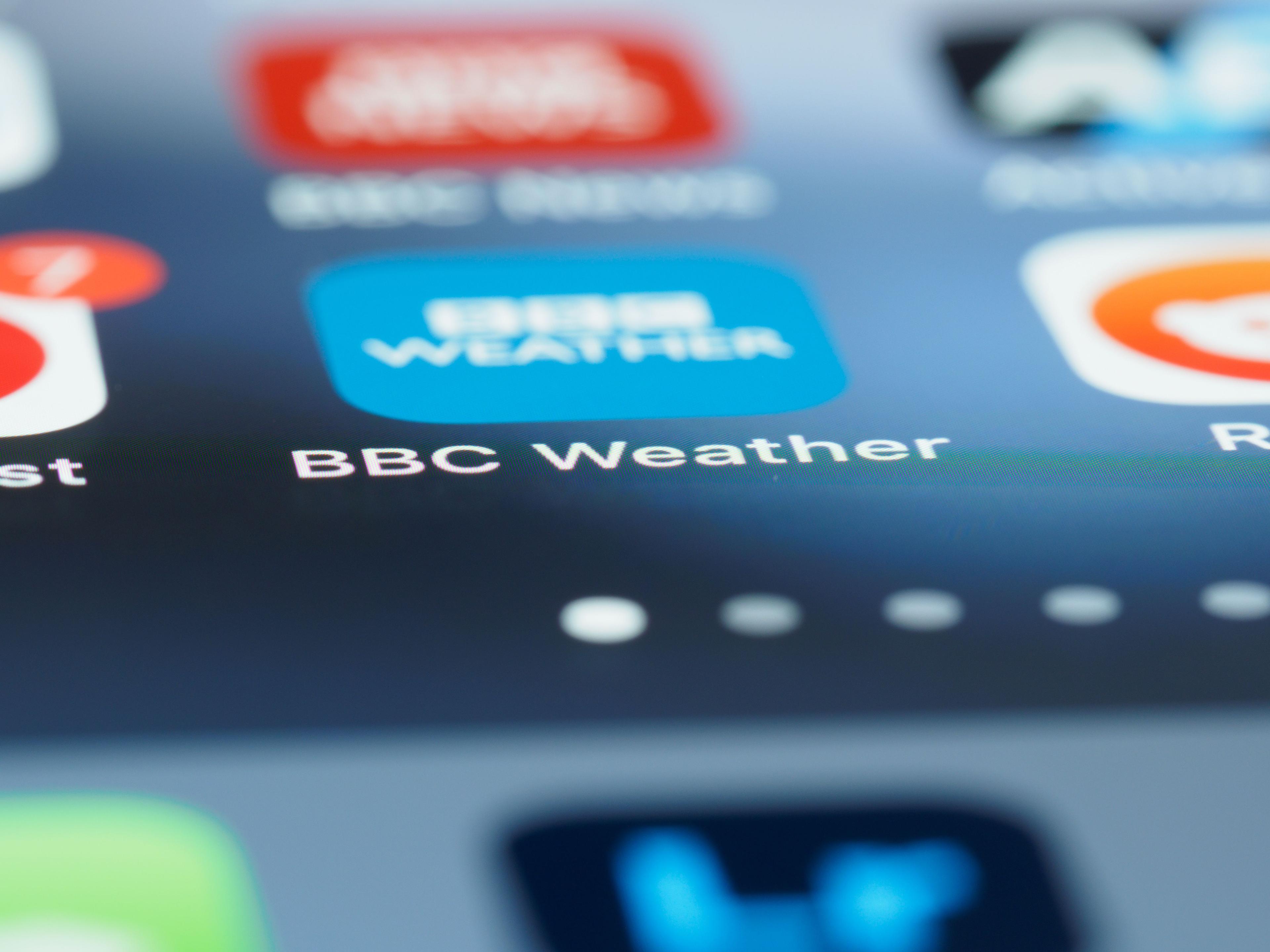 Checking a weather forecast app on a smartphone before driving during Korea typhoon season