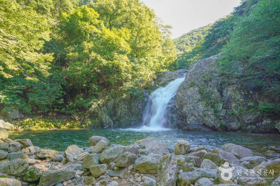 Yongchu Waterfall cascading down rocky cliffs into a natural pool in Hamyang, South Gyeongsang Province
