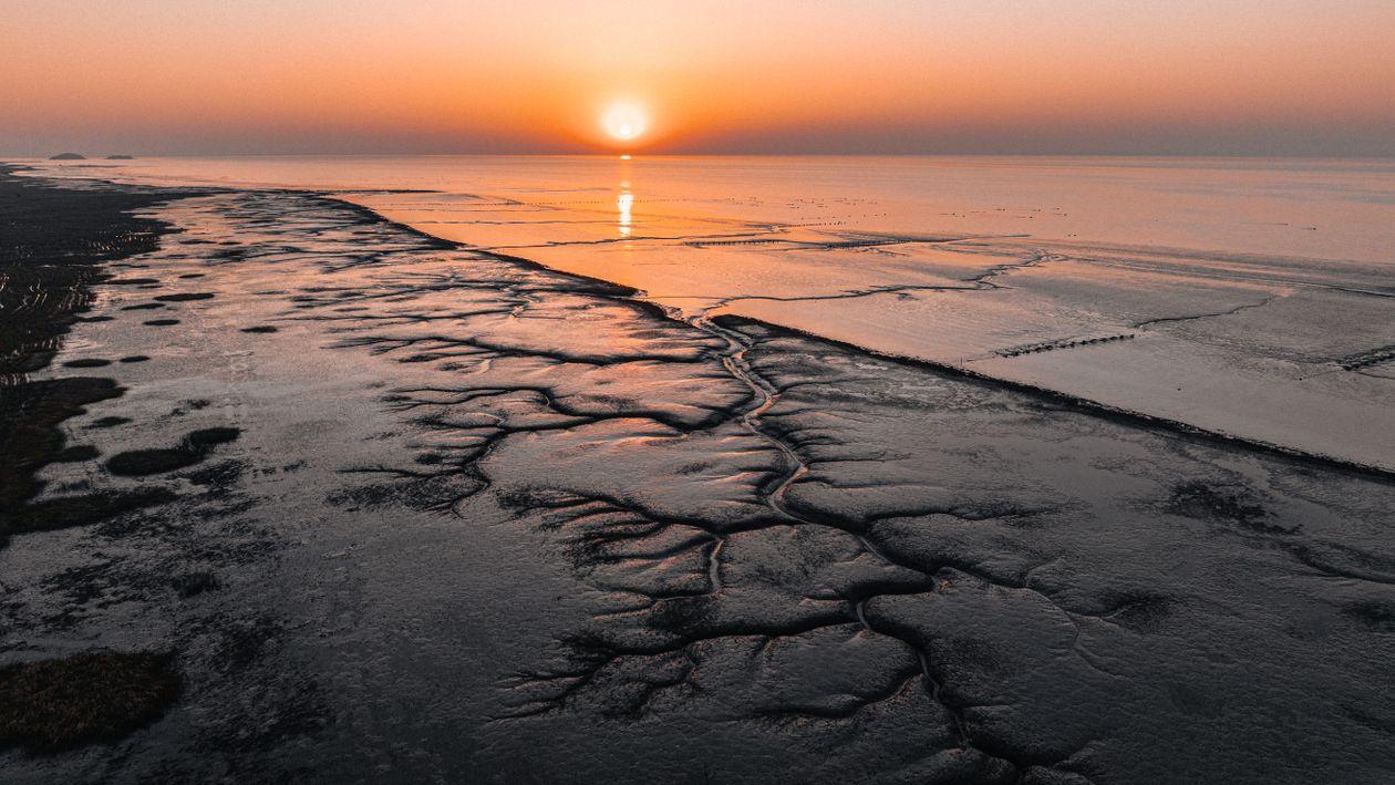 Tidal flat causeway between Muuido and Silmido island in Incheon at low tide, people walking across