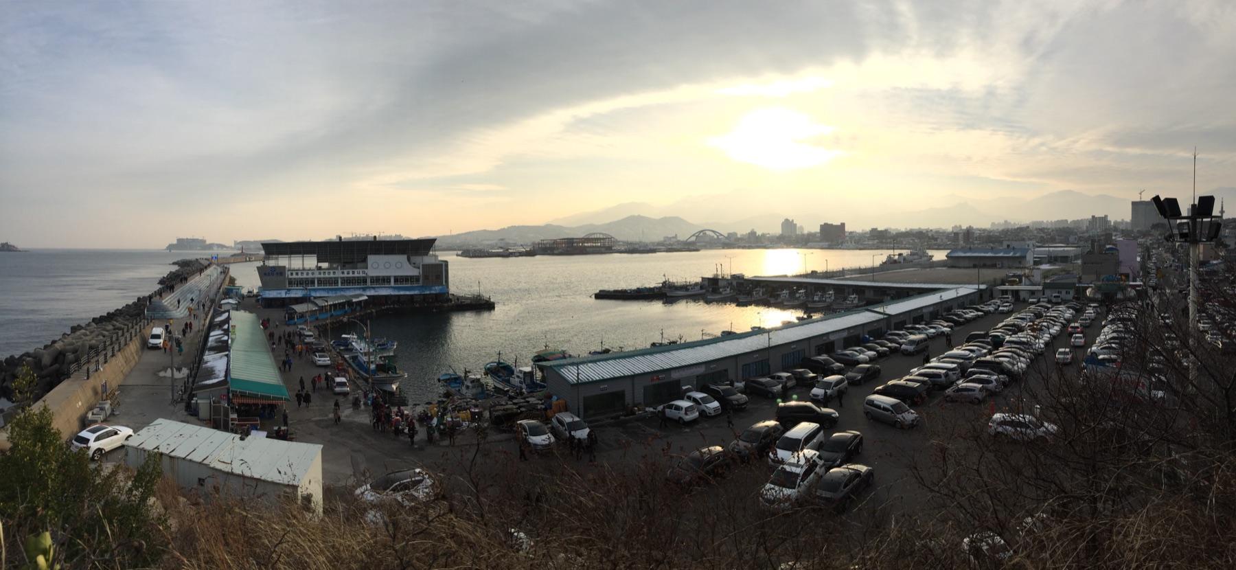 Dongmyeong fishing port in Sokcho, Korea at sunset with squid boats and lighthouse